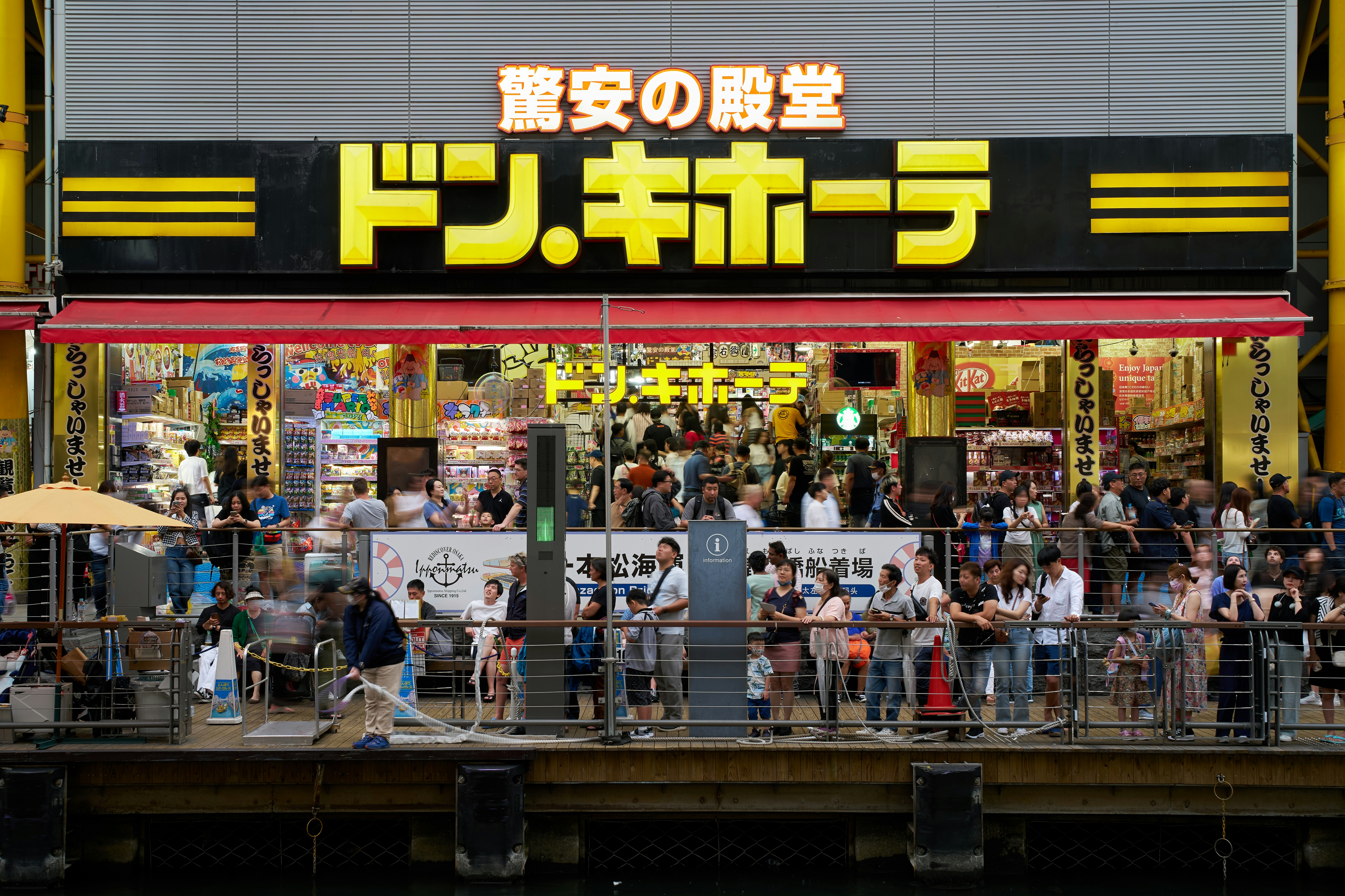 a group of people standing outside of a store