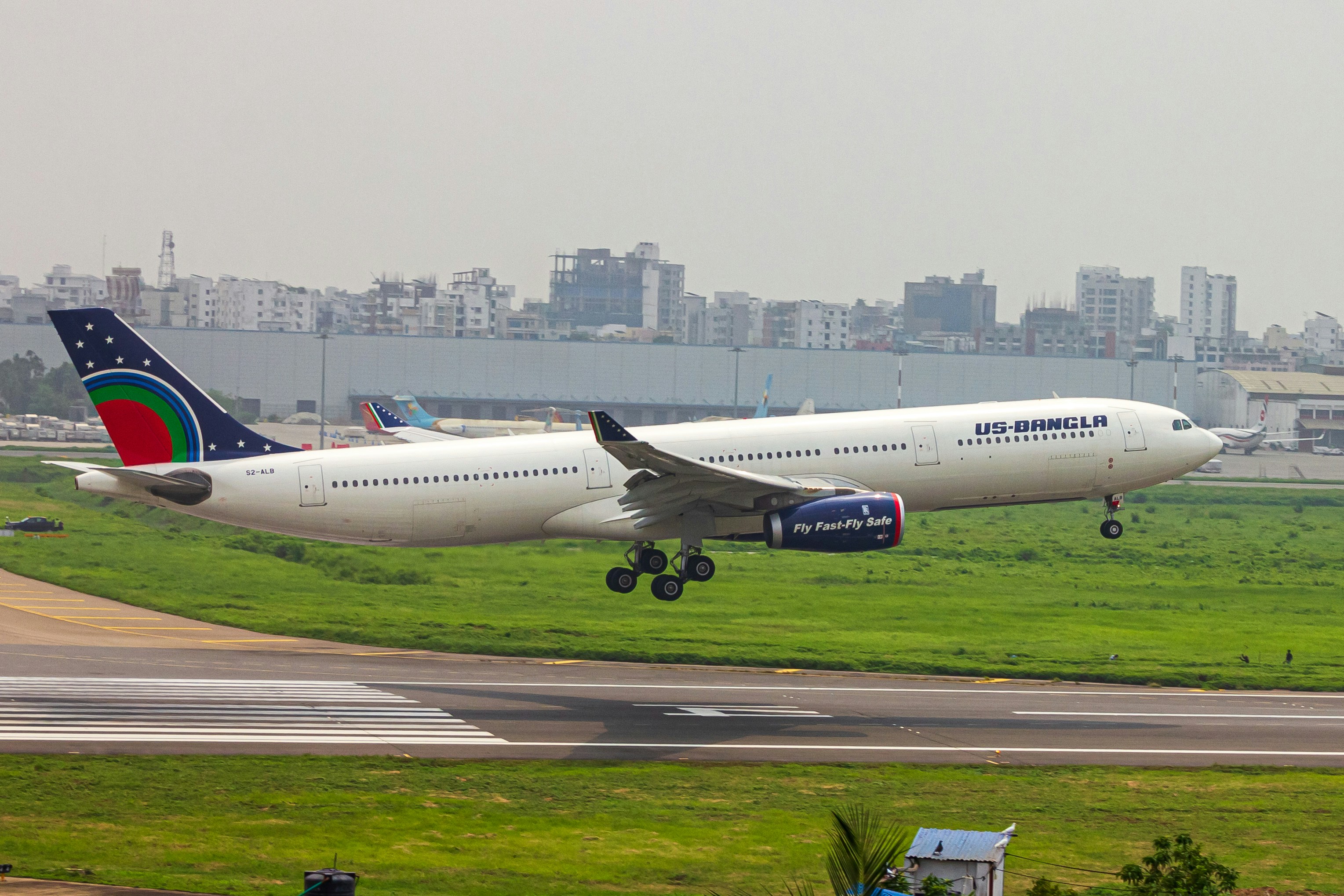 a large jetliner taking off from an airport runway, US BANGLA A333 moments before TOUCHDOWN 💨