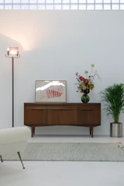 A living room with white walls and a white rug