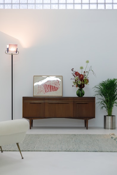 A living room with white walls and a white rug