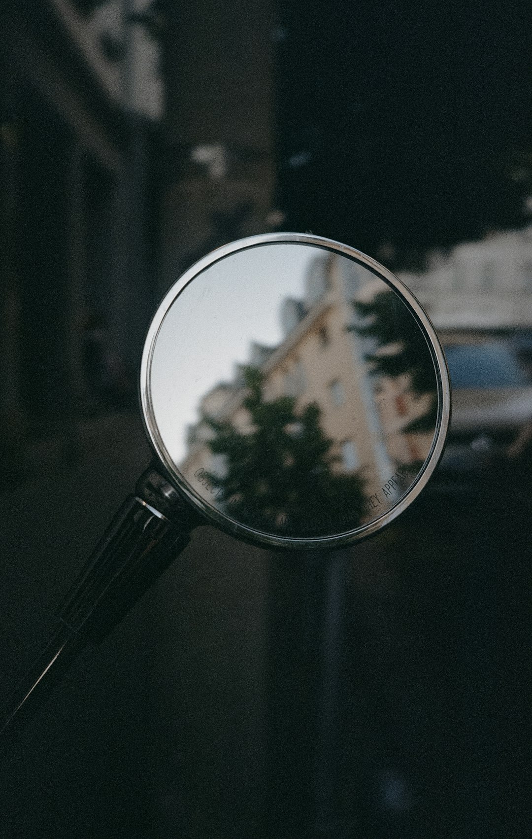 A close up of a magnifying glass with a building in the background