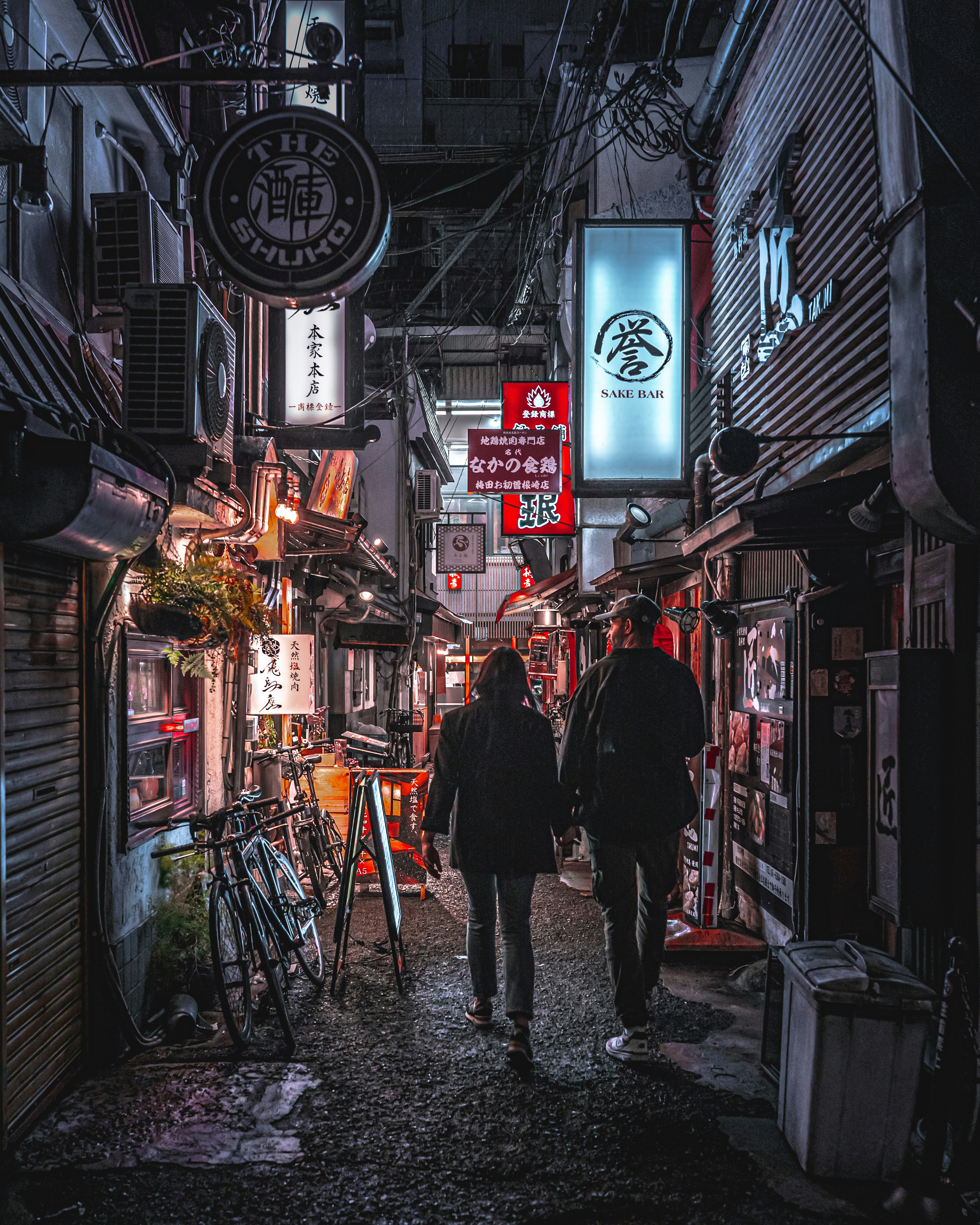 Dos personas caminando por un estrecho callejón