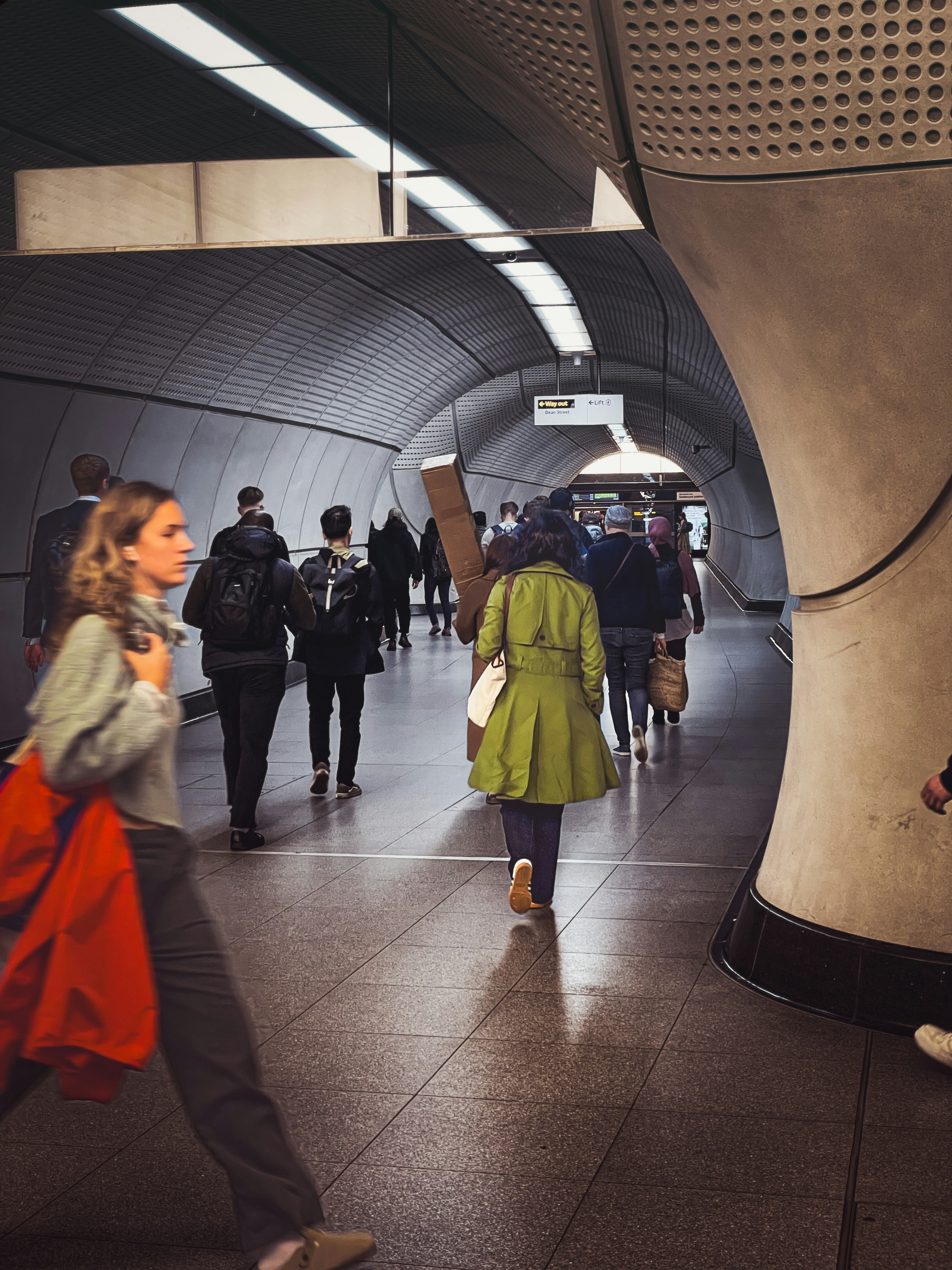 A group of people walking through a tunnel