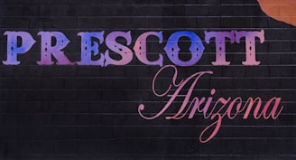 A sign that says prescot arizona with a guitar on it