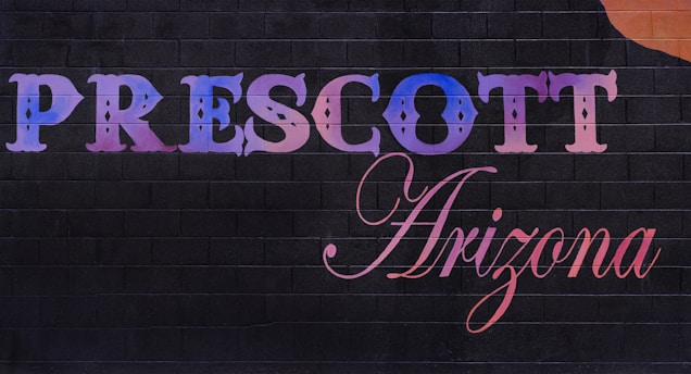 A sign that says prescot arizona with a guitar on it