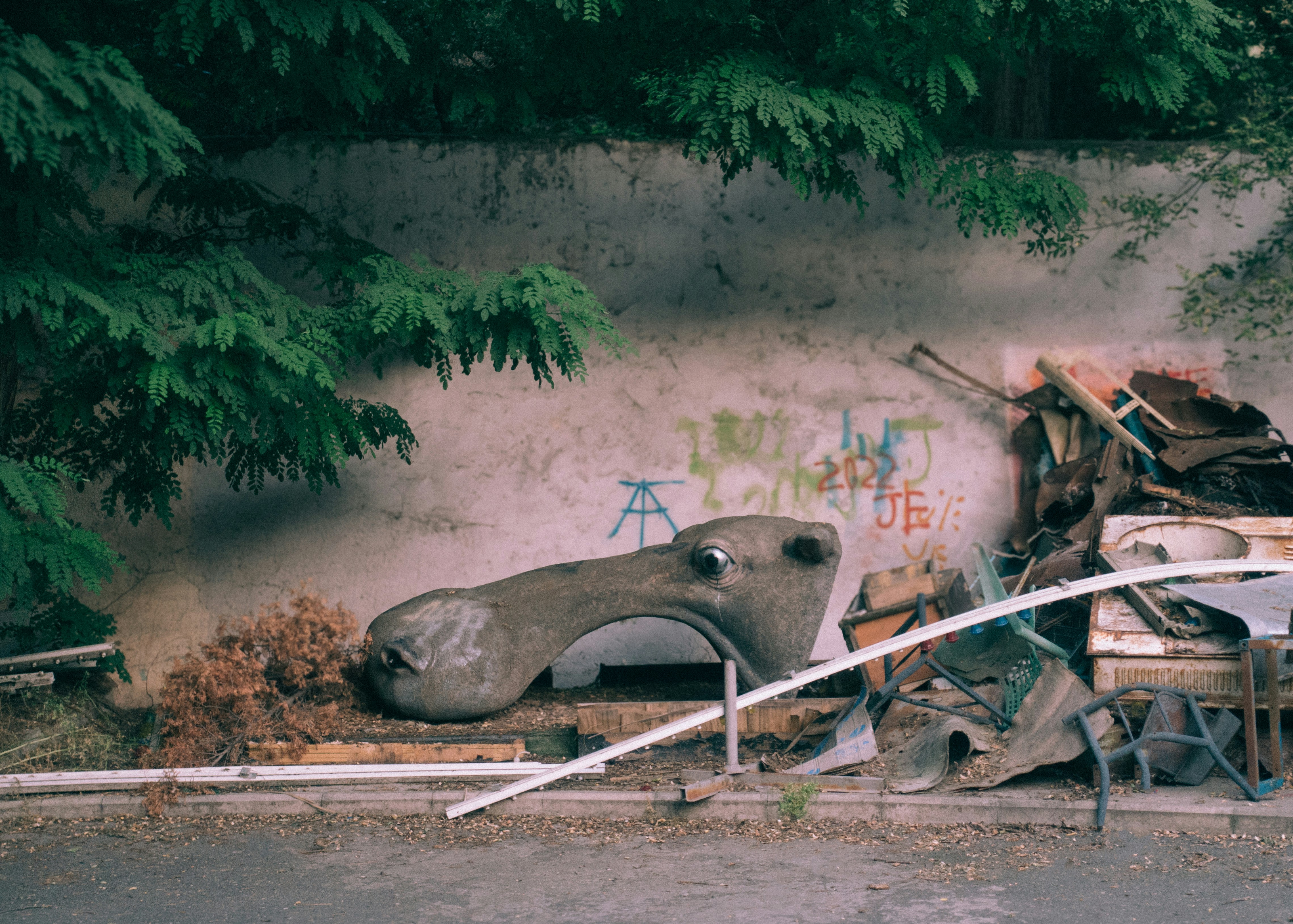 A pile of junk sitting on the side of a road photo – Free Graffiti ...