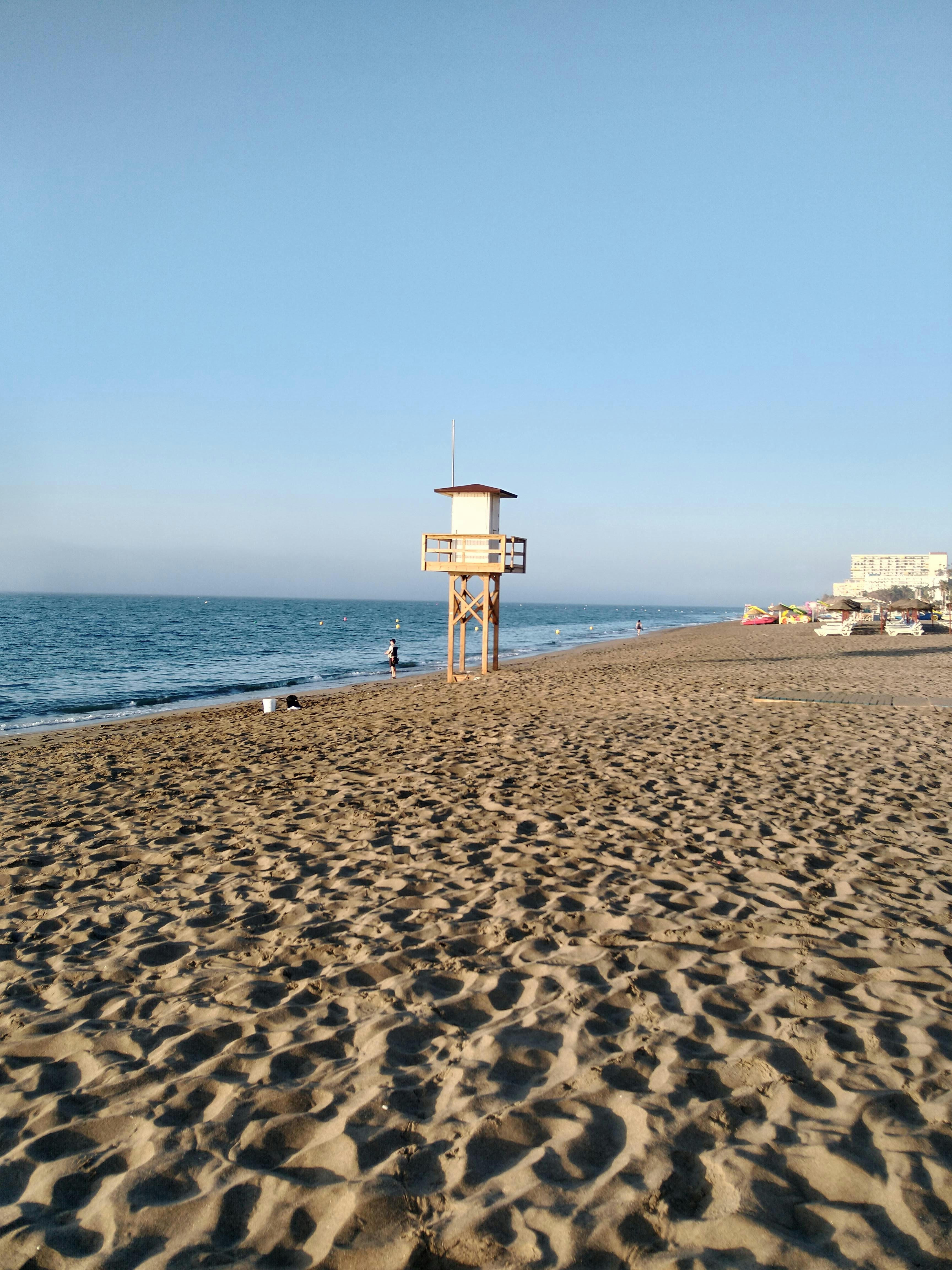 A lifeguard tower on a beach next to the ocean