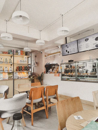 A restaurant with tables, chairs, and menus on the wall