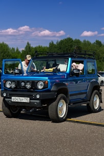 A blue jeep is parked in a parking lot