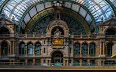 A train station with a large glass ceiling