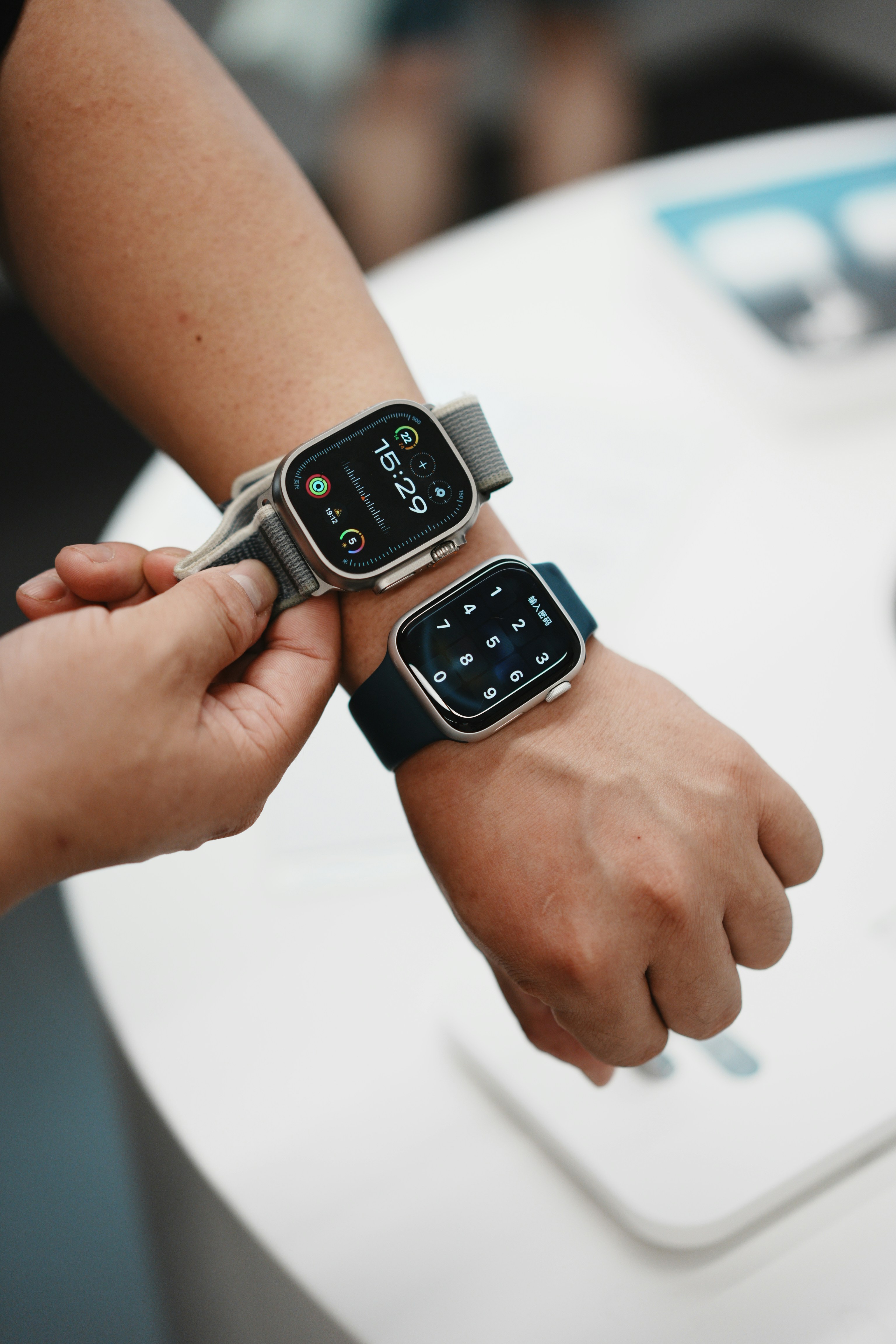 A couple of people that are holding onto some wrist watches