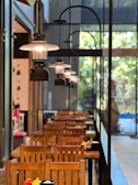 A restaurant with wooden tables and wooden chairs