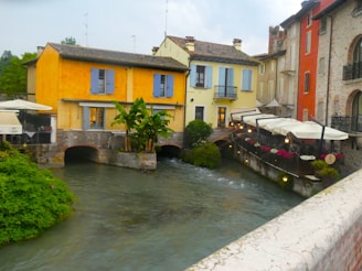A river running through a city next to tall buildings