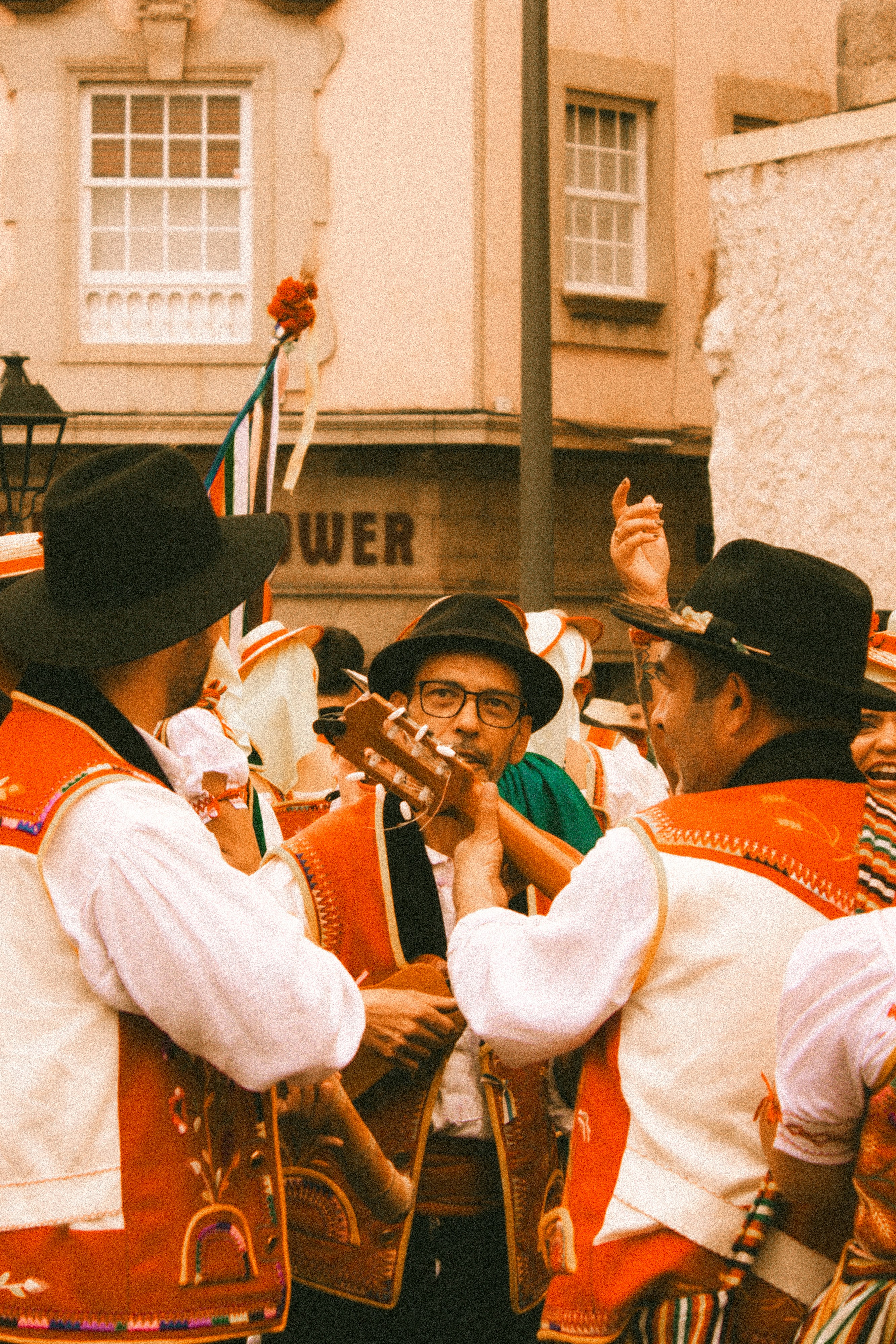 A group of men standing next to each other in front of a building