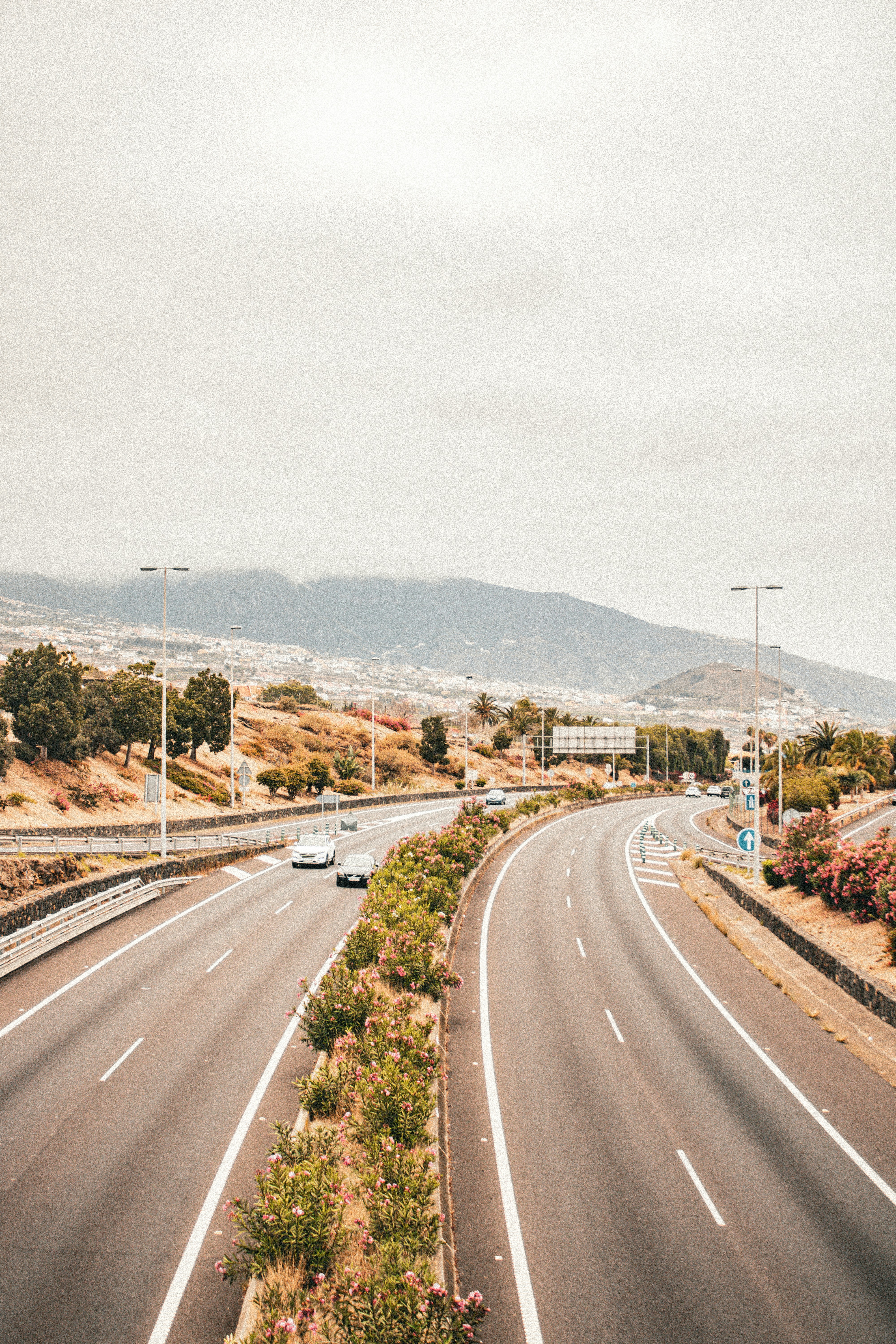 A highway with a few cars driving down it