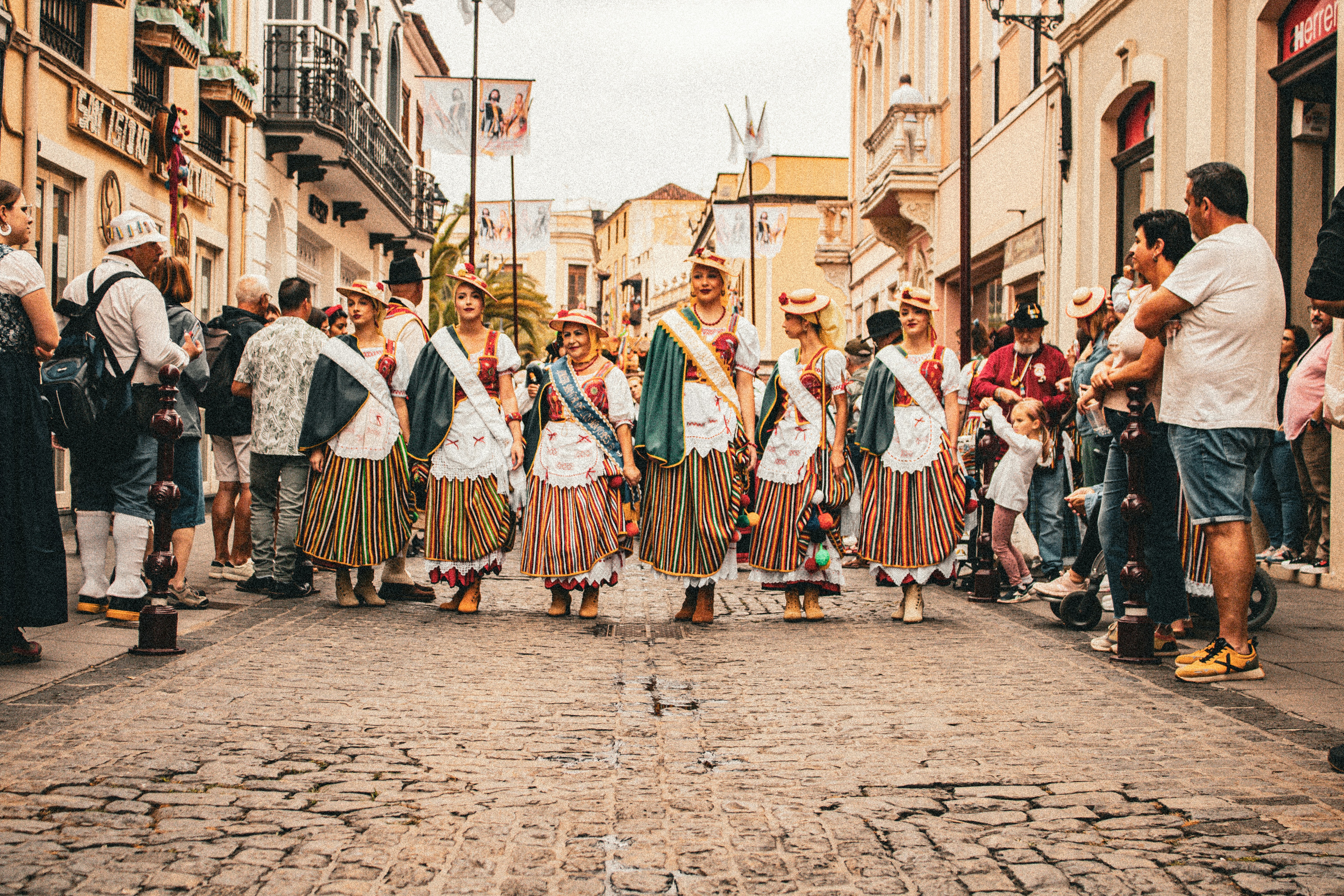 A group of people standing in the middle of a street