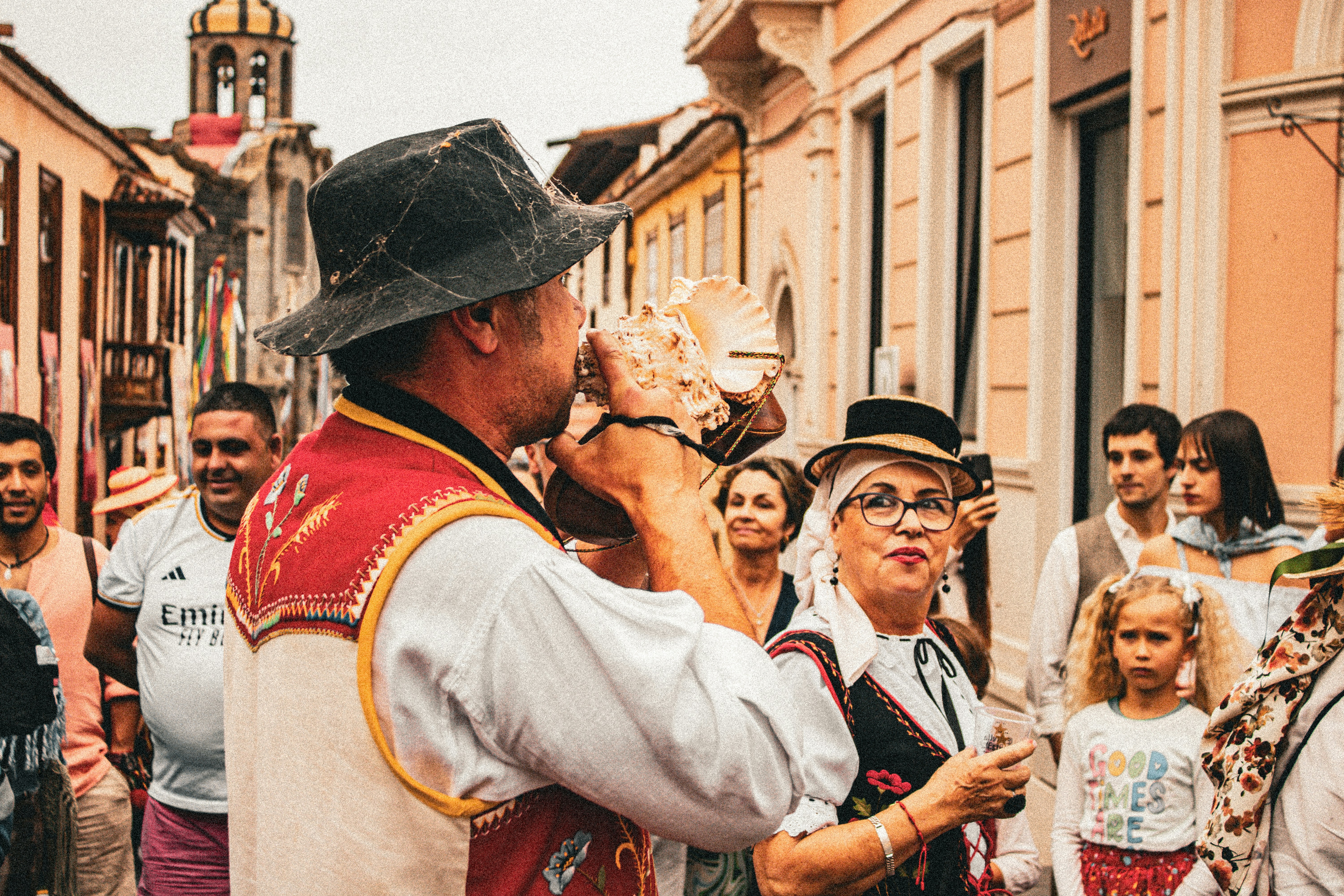 A group of people standing on a street next to each other