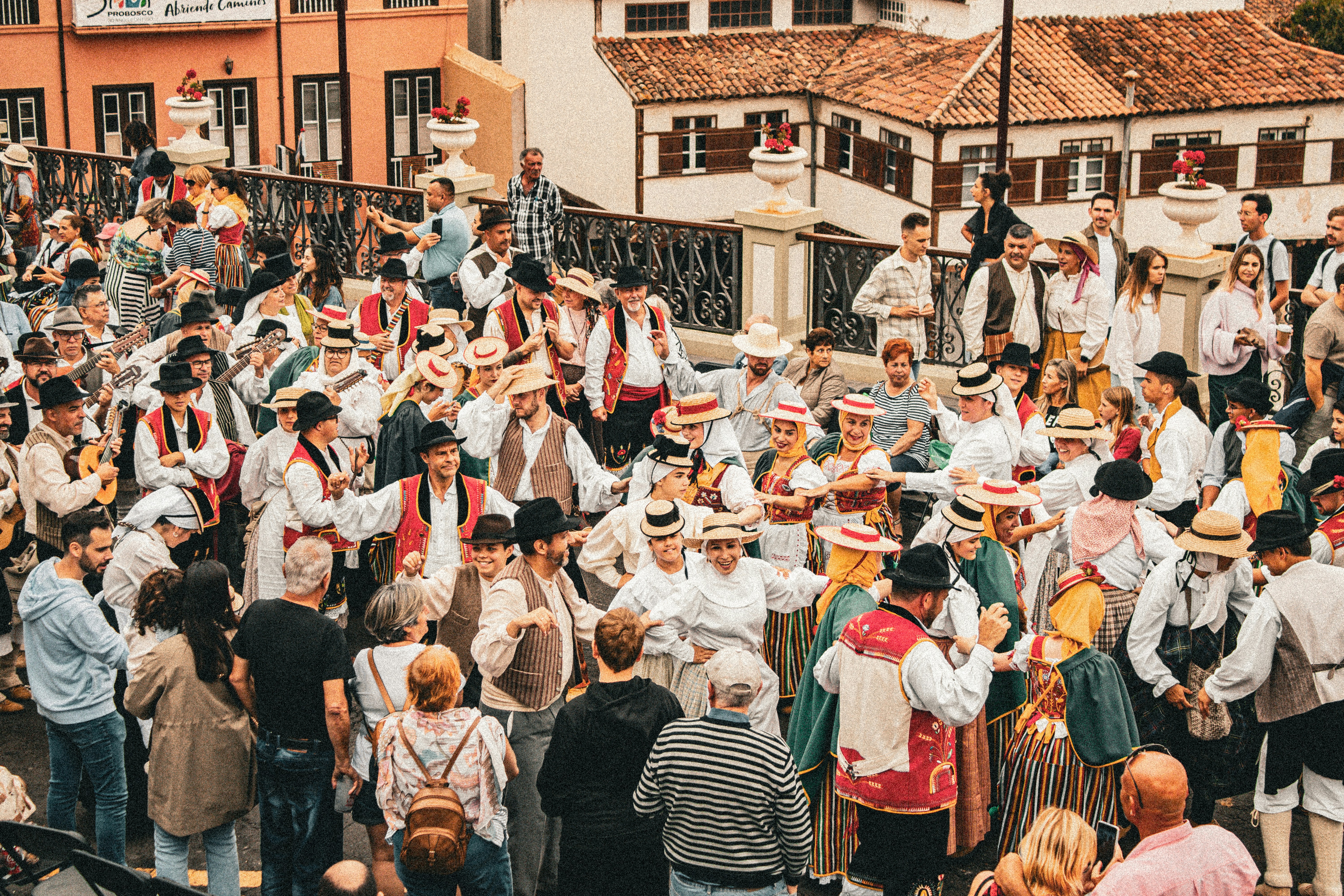 A crowd of people standing around each other