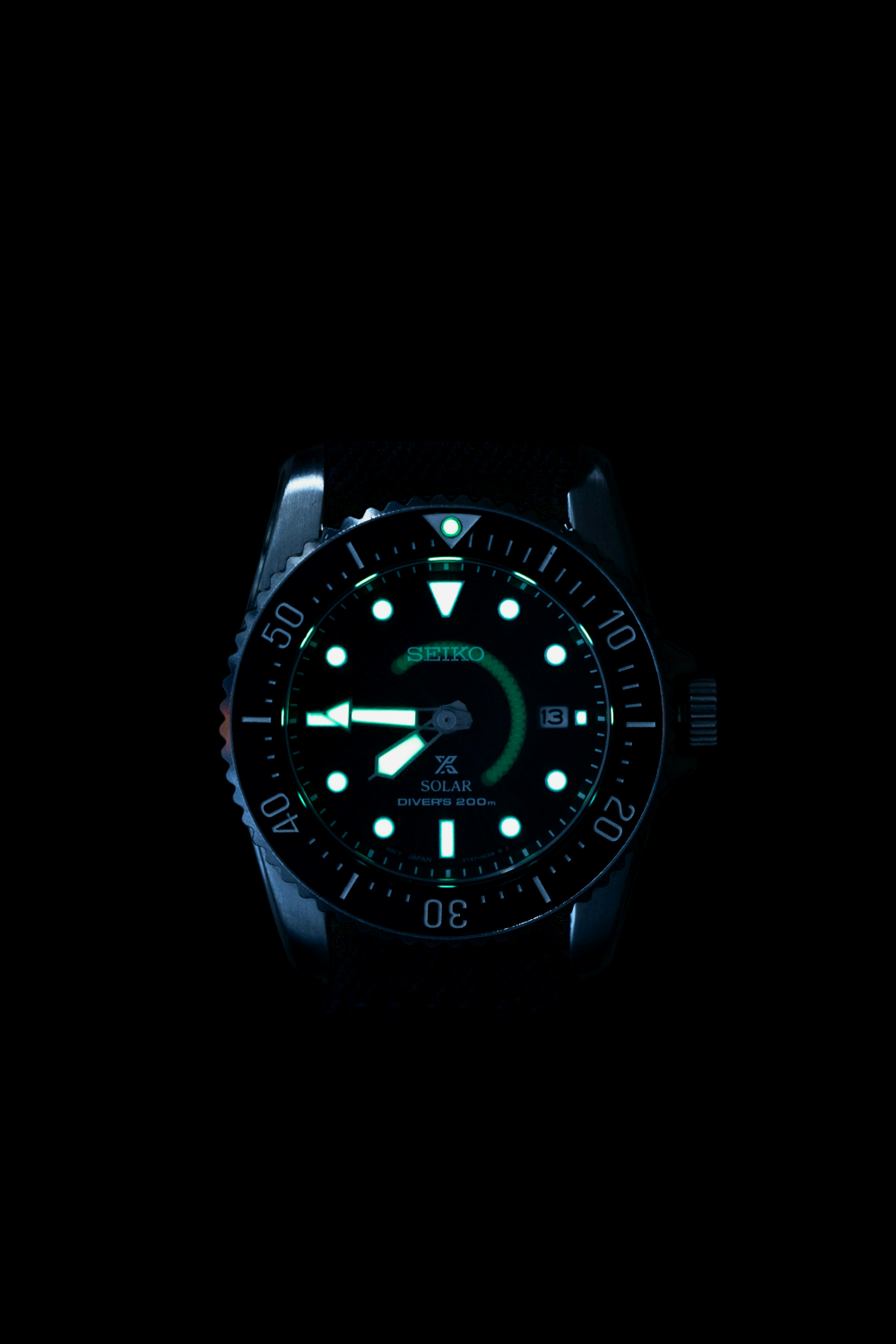 A black watch with a green light on it