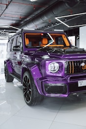 A purple jeep parked inside of a garage