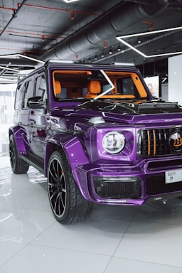 A purple jeep parked inside of a garage