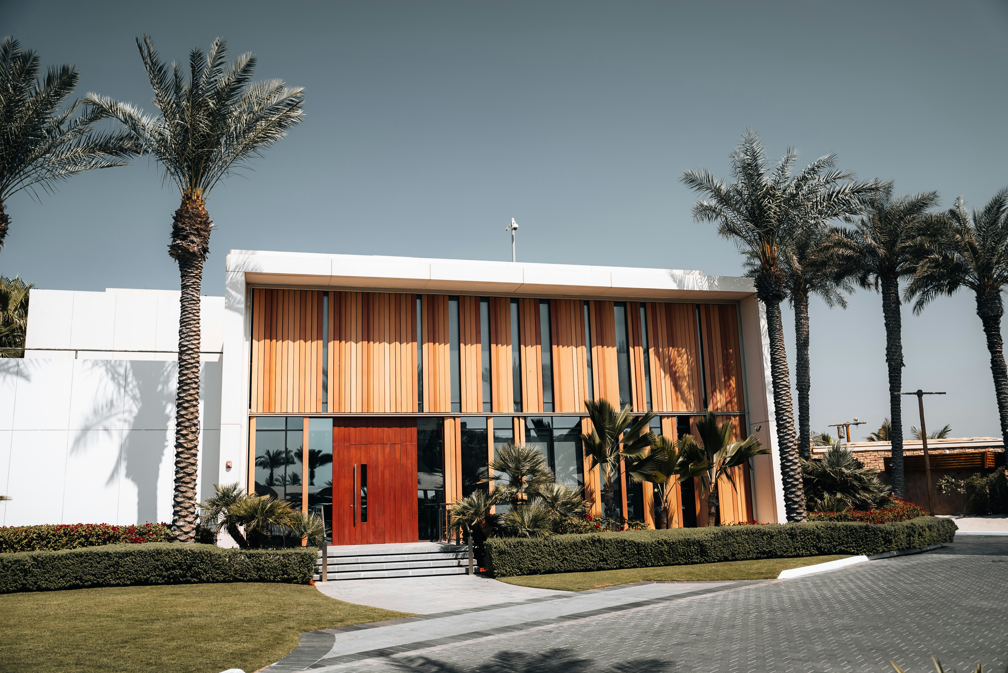 A large building with palm trees in front of it