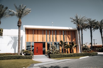 A large building with palm trees in front of it