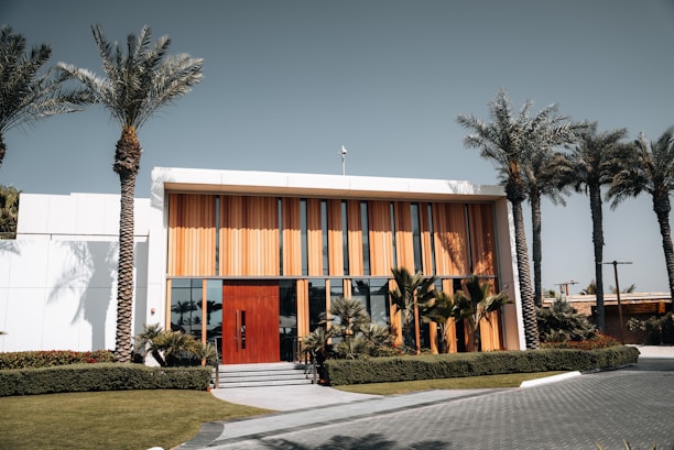 A large building with palm trees in front of it