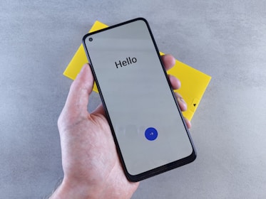 A person holding a cell phone in their hand