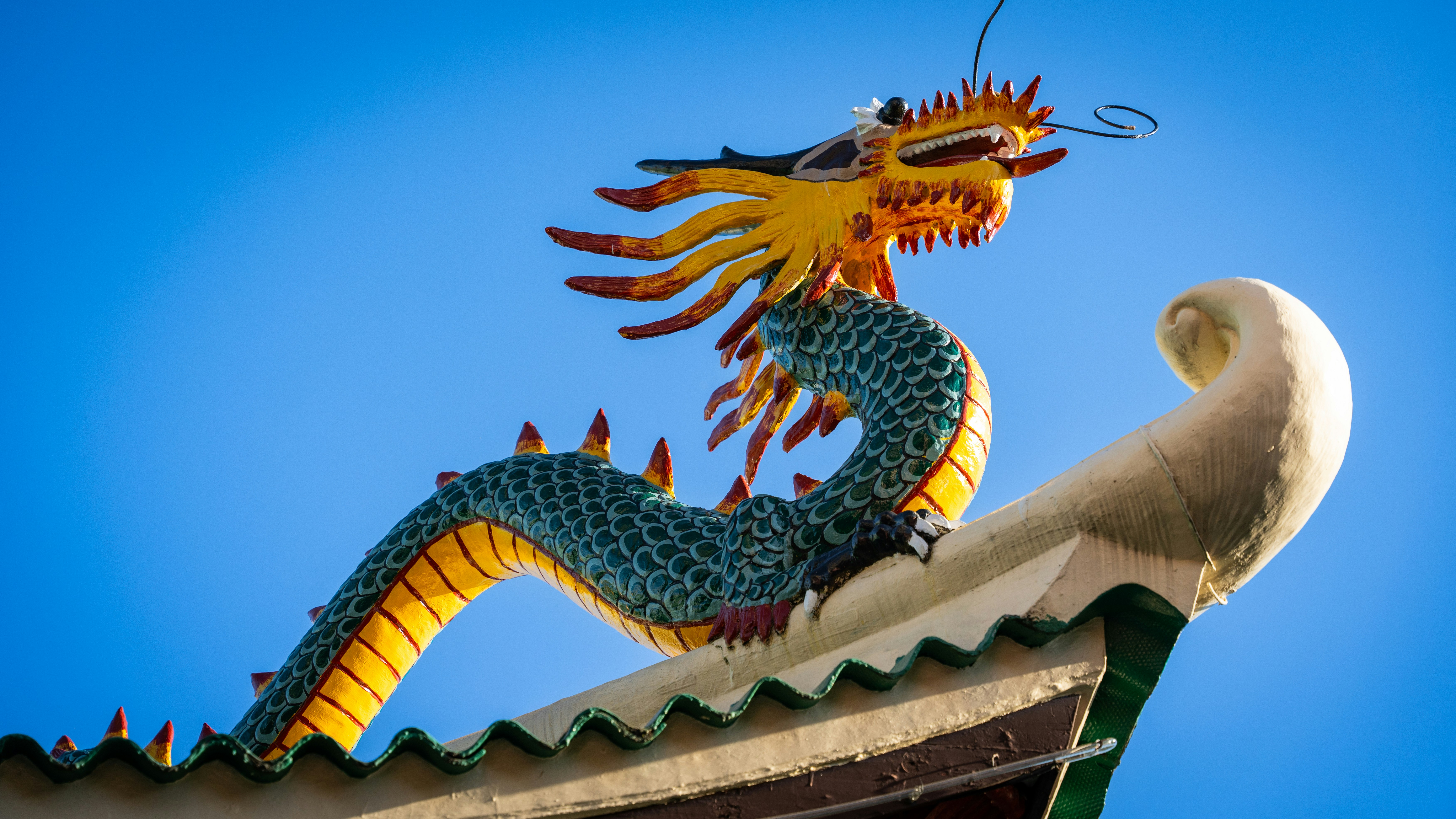 View of a rock dragon on top of a taoist temple with blue sky in Cebu City, Philippines.