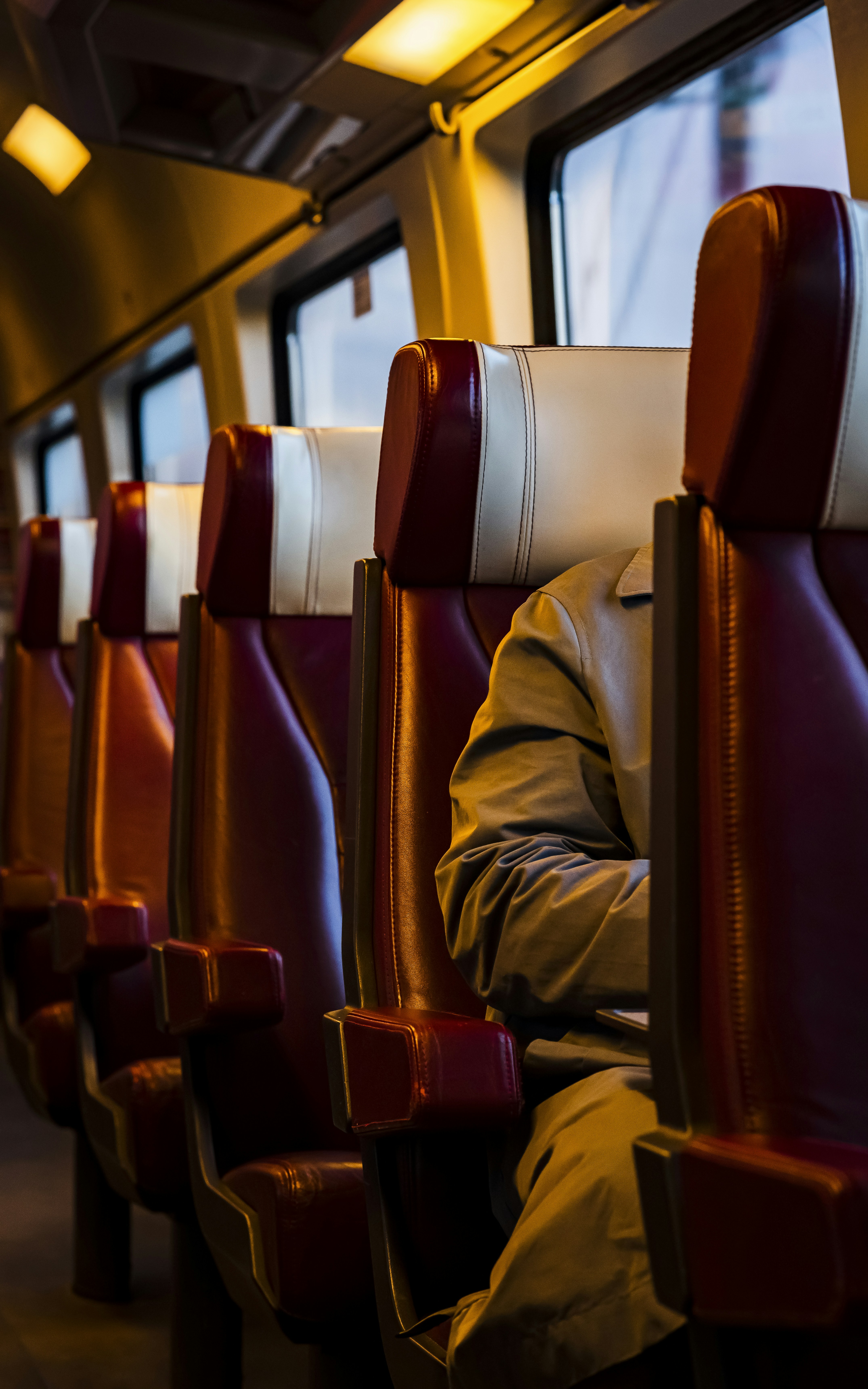 A man sitting on a bus with his laptop