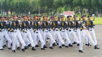 A group of men in uniform marching down a street