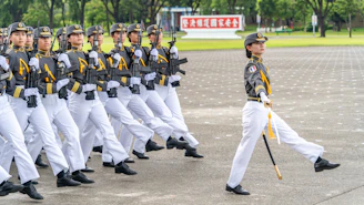 A group of men in uniform marching down a street