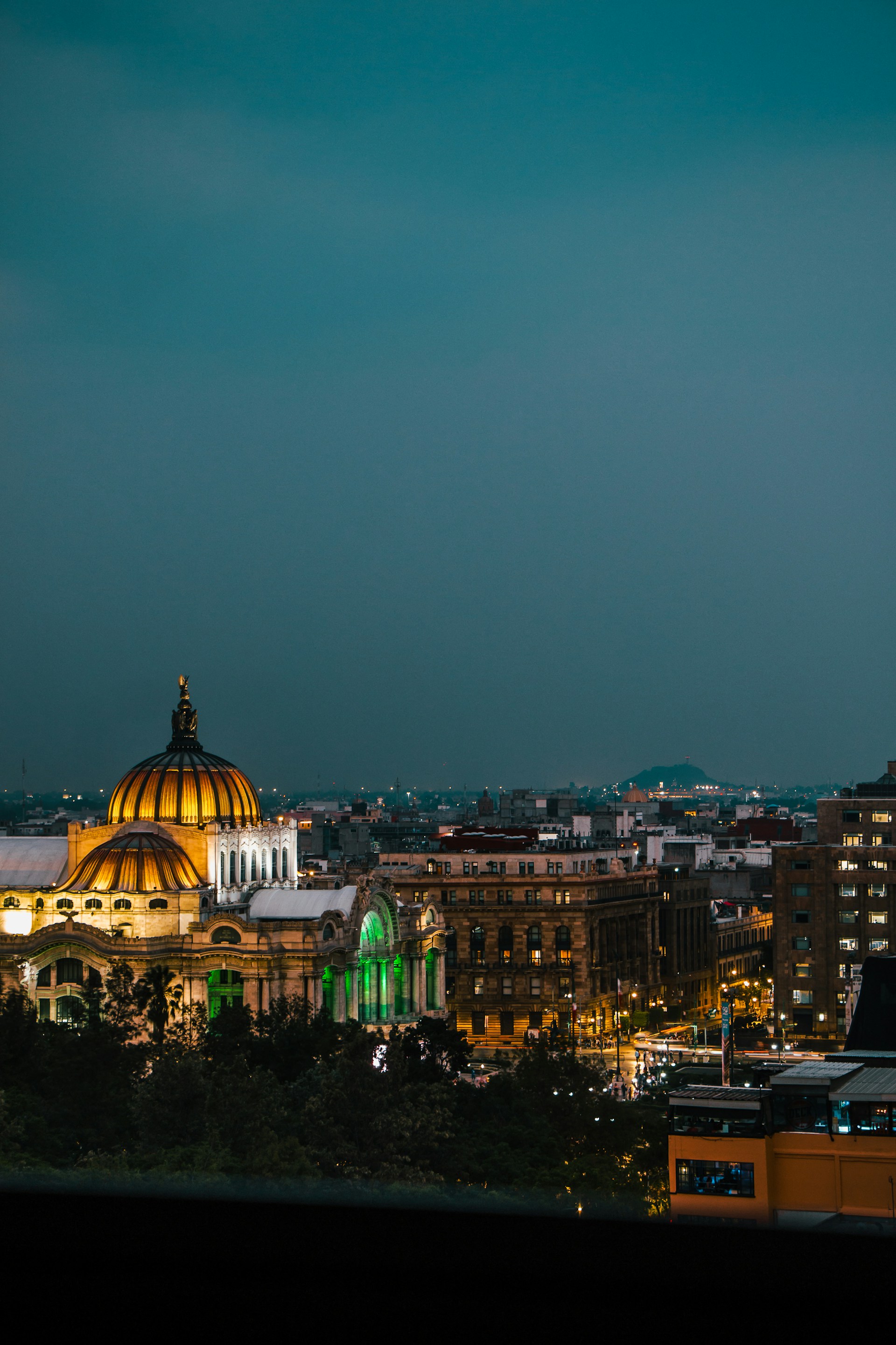 A view of a city at night from a rooftop