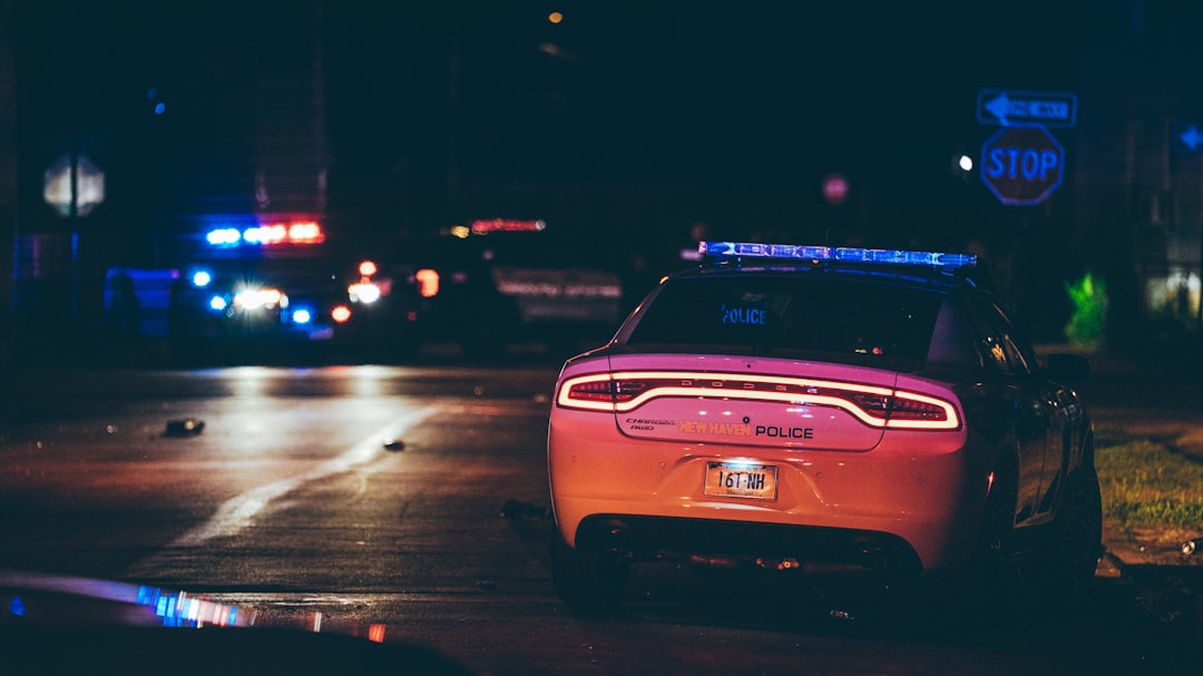 A police car parked on the side of the road,