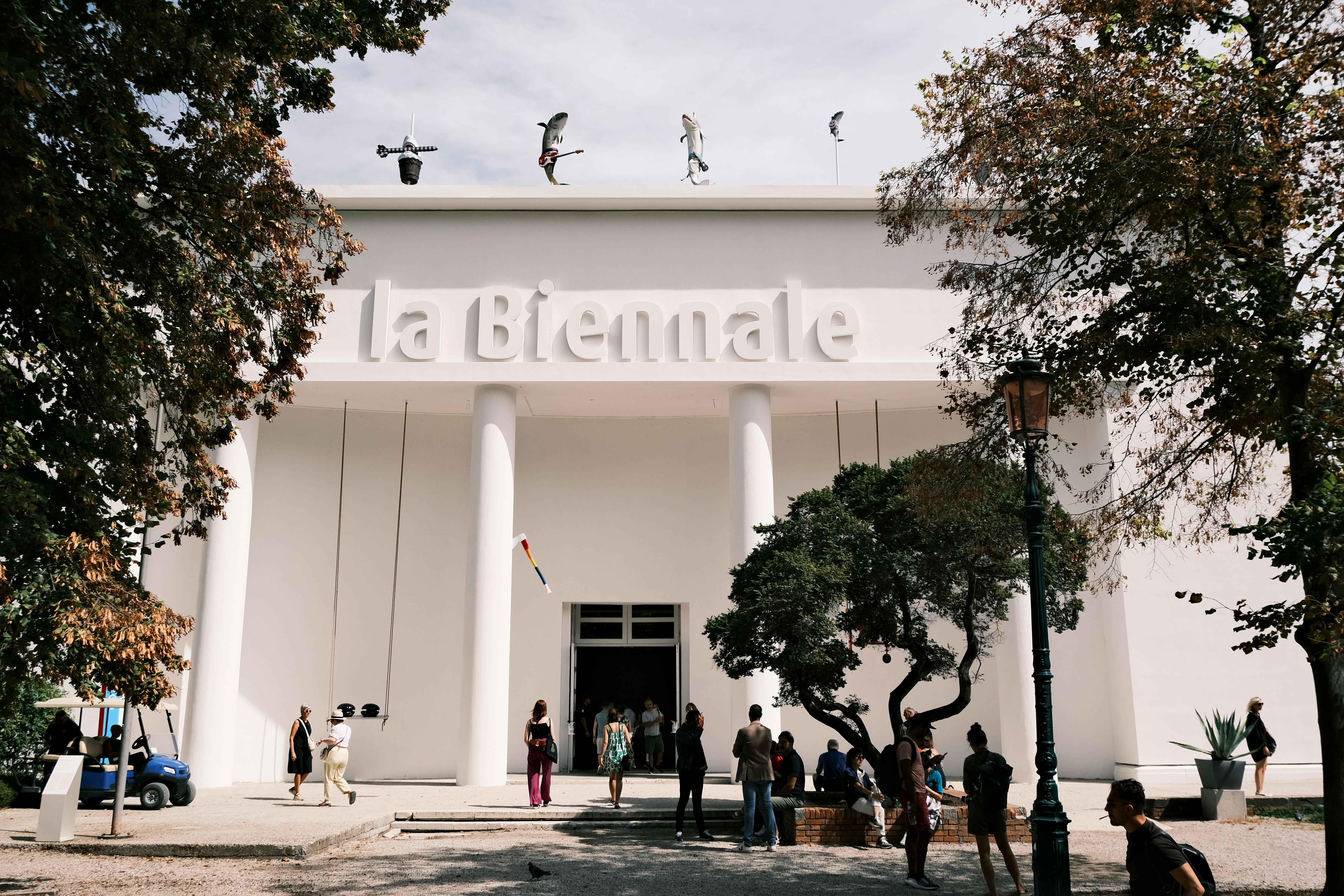 A group of people standing outside of a white building