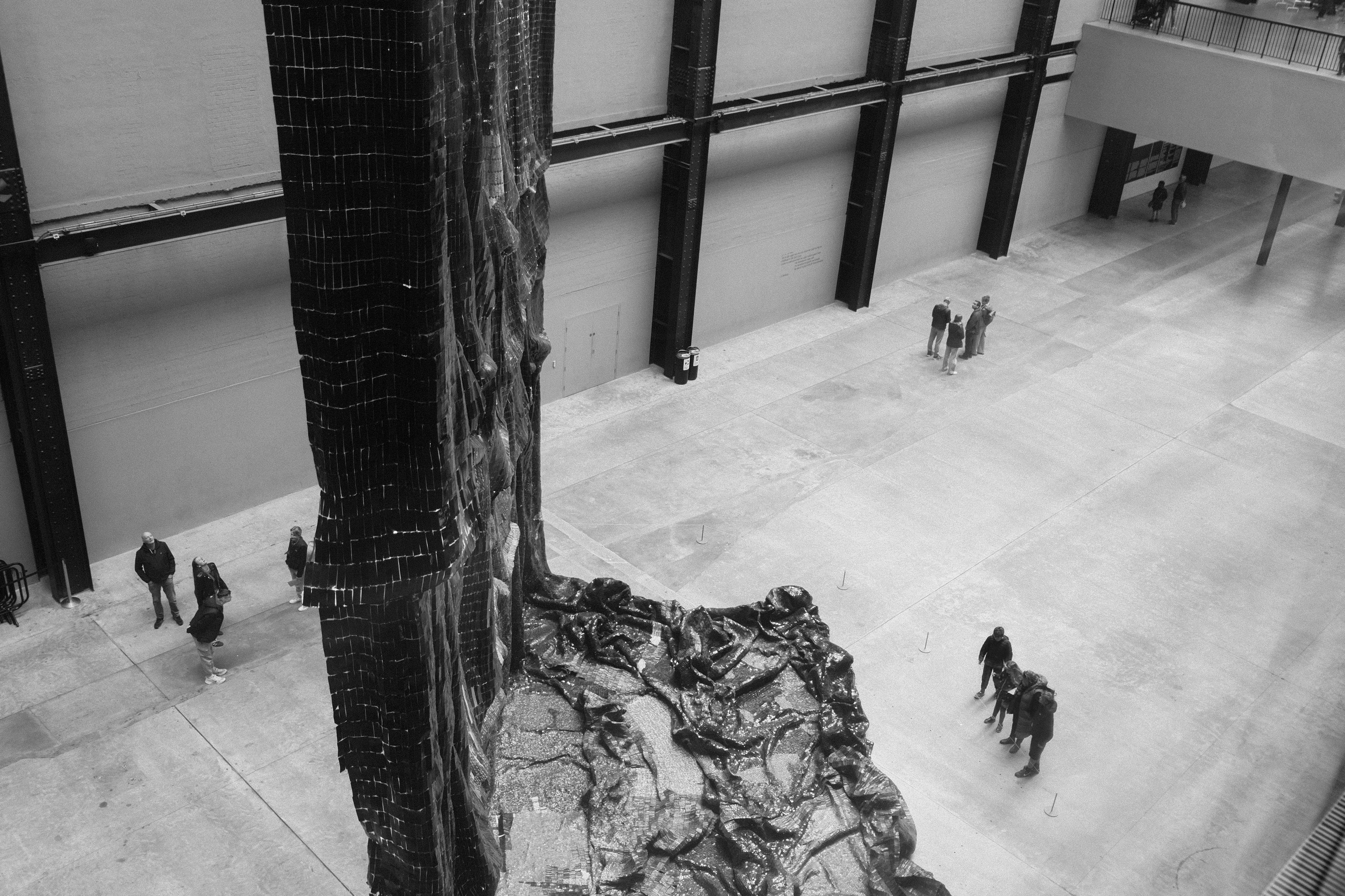 A black and white photo of people in a building