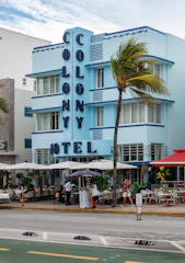 A blue building with a palm tree in front of it