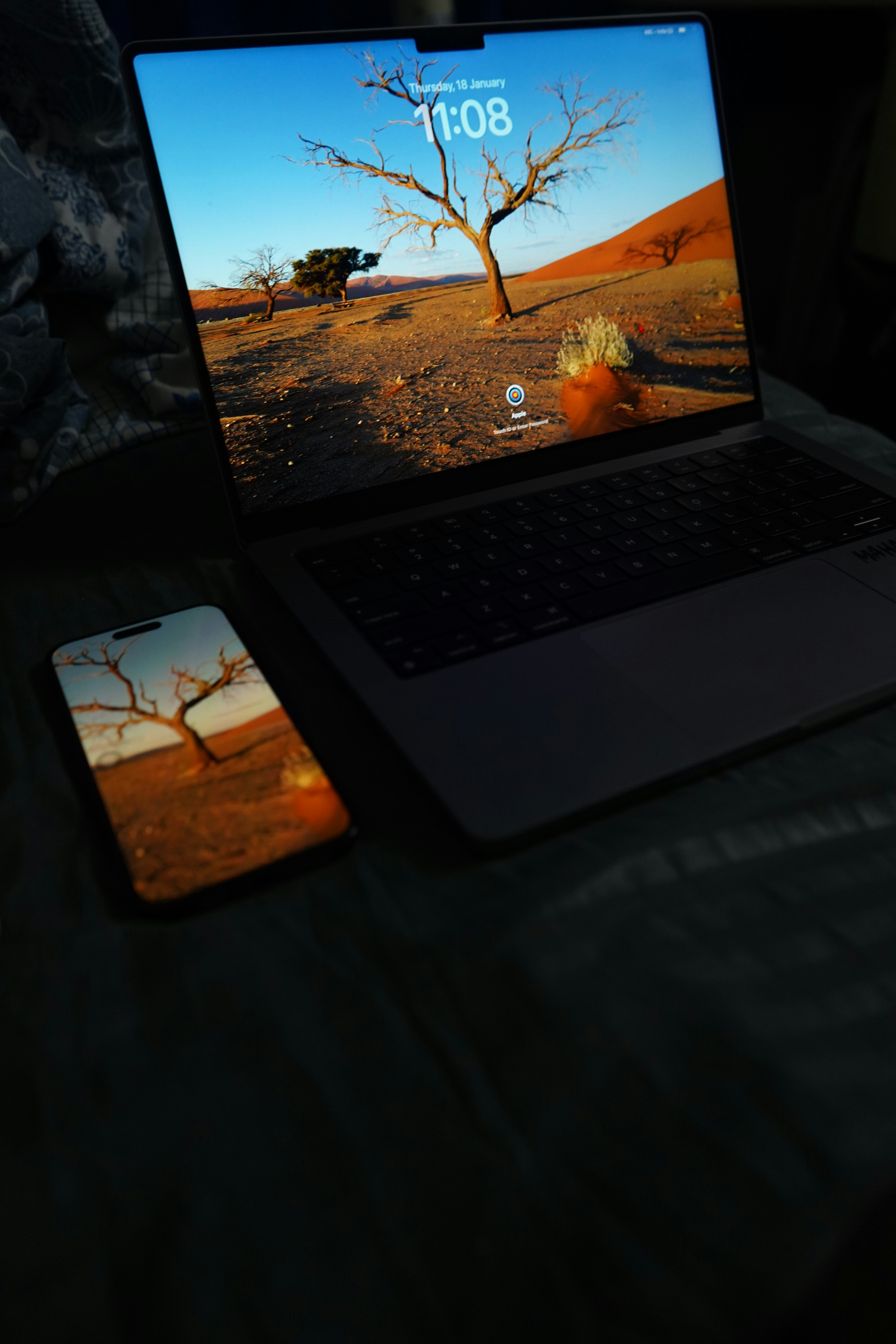 A laptop computer sitting on top of a bed