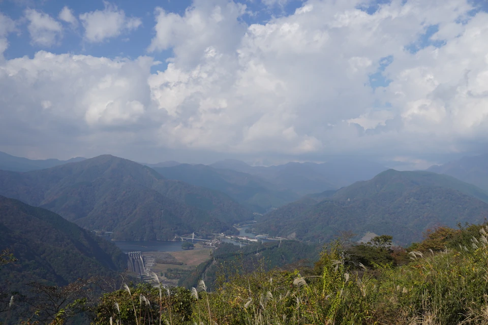 Mountainous landscape with valley between two towering peaks under clear blue sky