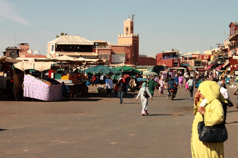 A group of people walking around a market