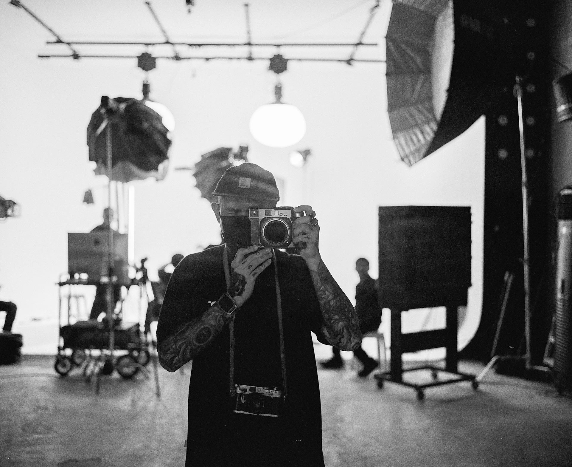A person holding a camera in a room