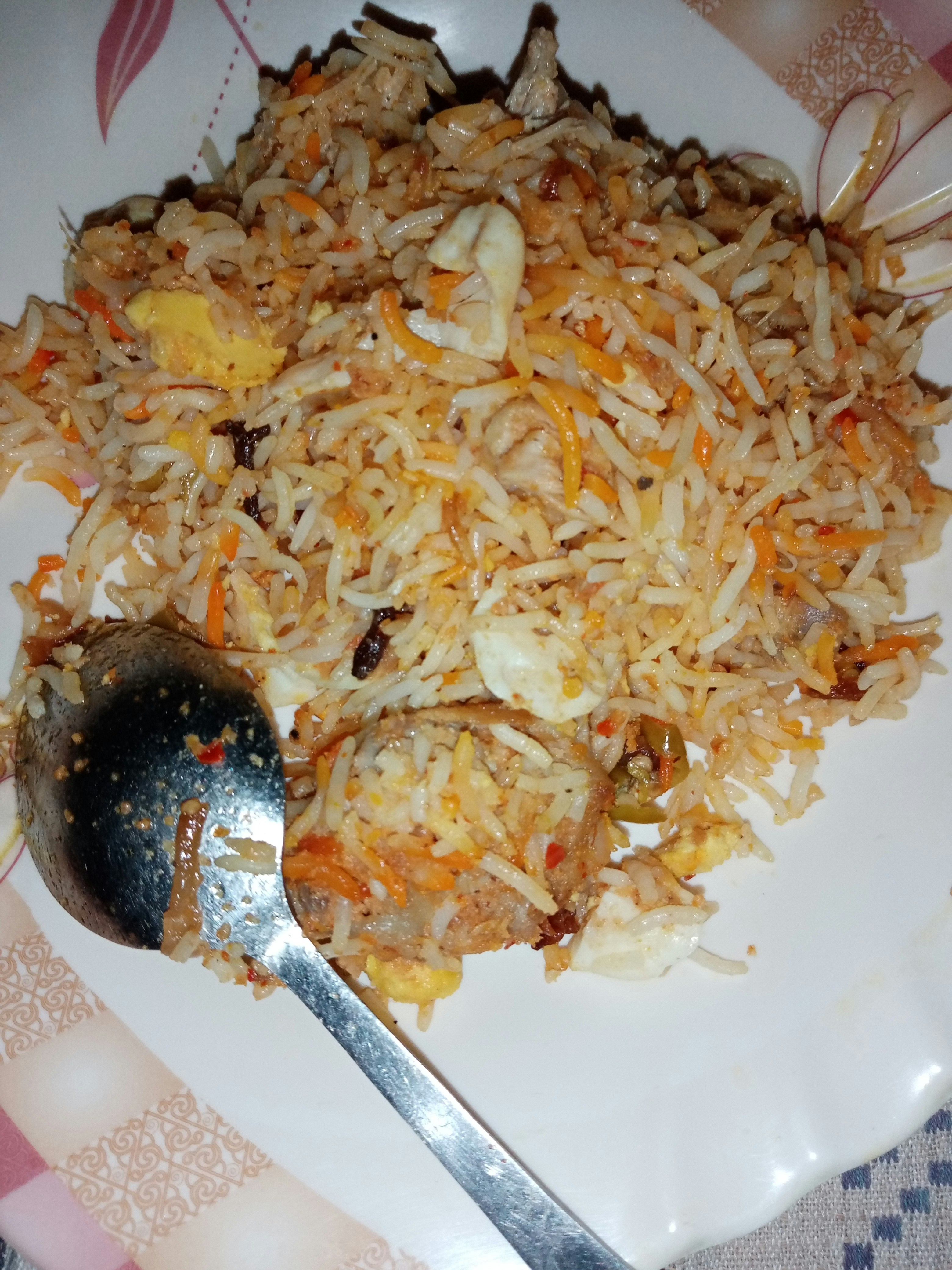 Deep orange biryani masala spice blend in a small bowl with saffron nearby