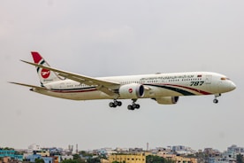 A large jetliner flying through a cloudy sky