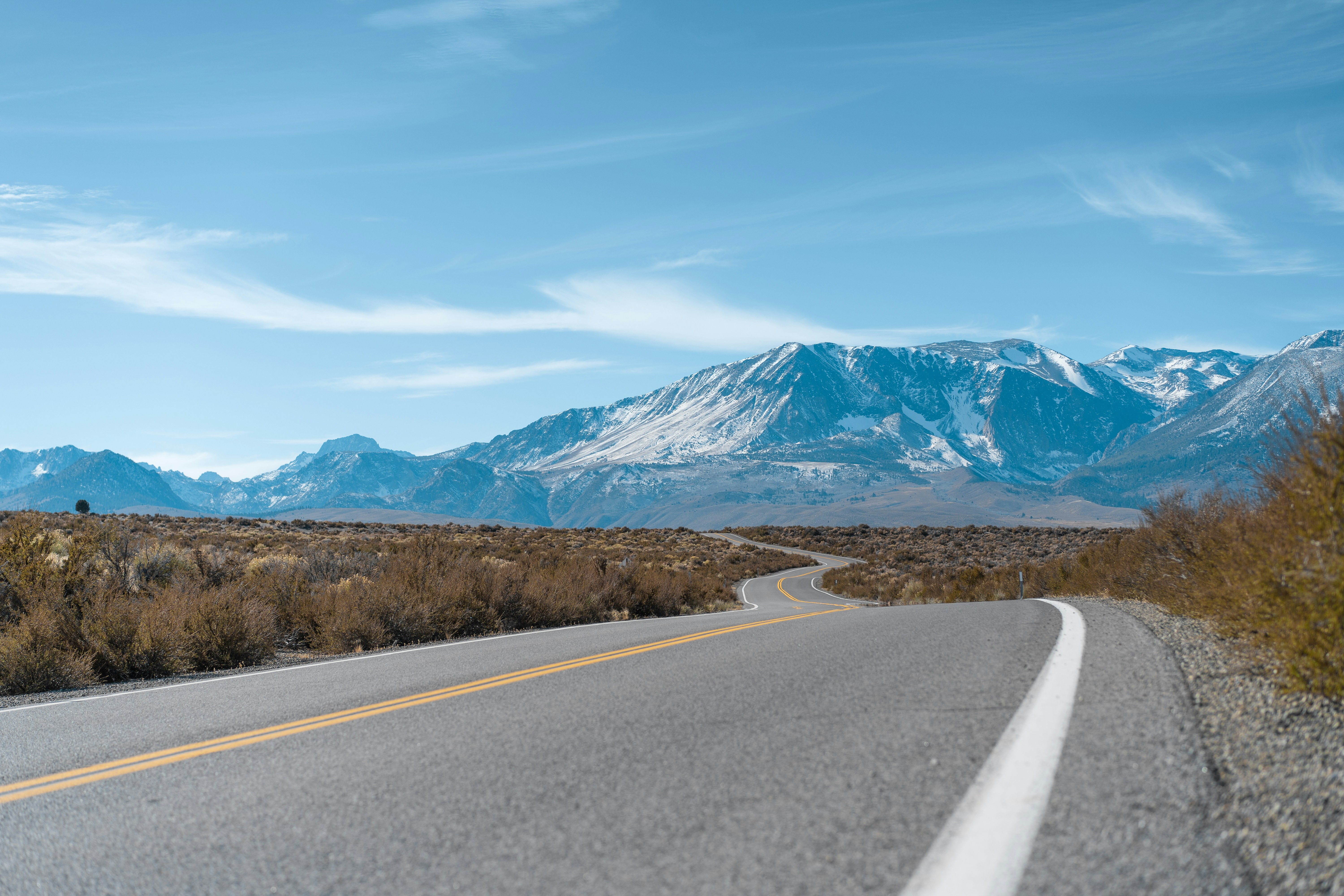 A view of a road with mountains in the background
