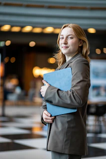 A woman in a suit holding a folder