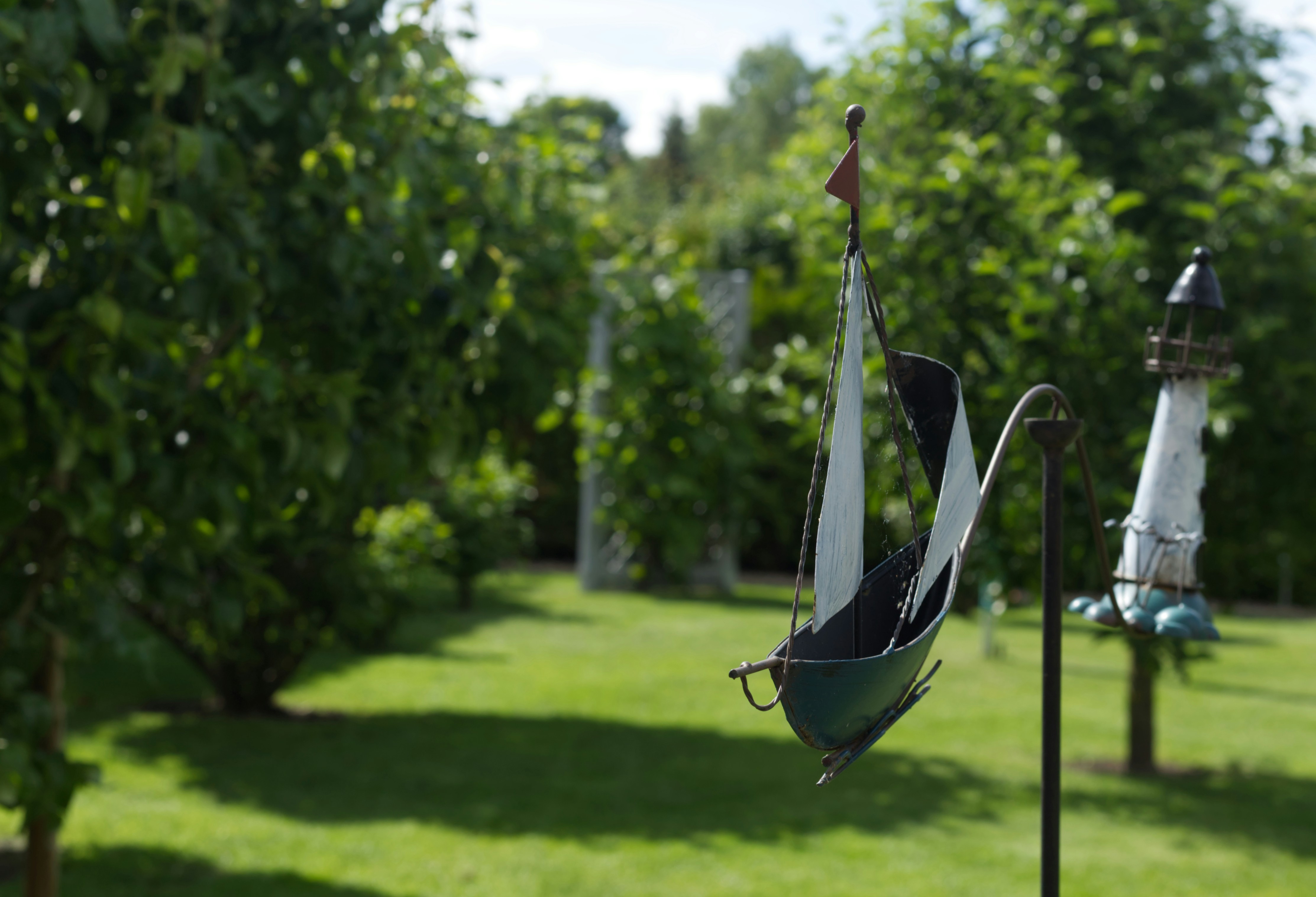 A sailboat is hanging from a pole in a yard