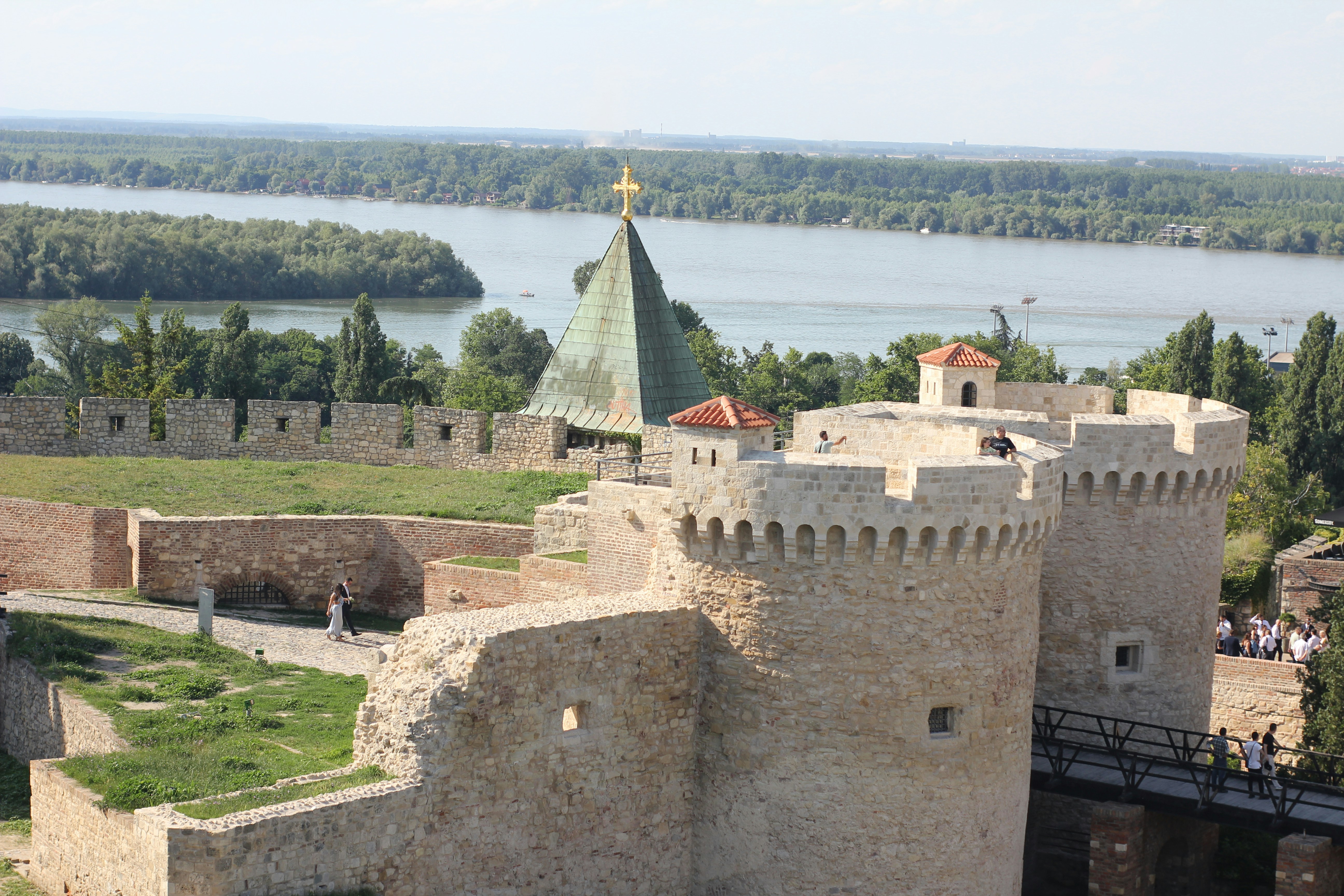 An aerial view of a castle with a river in the background
