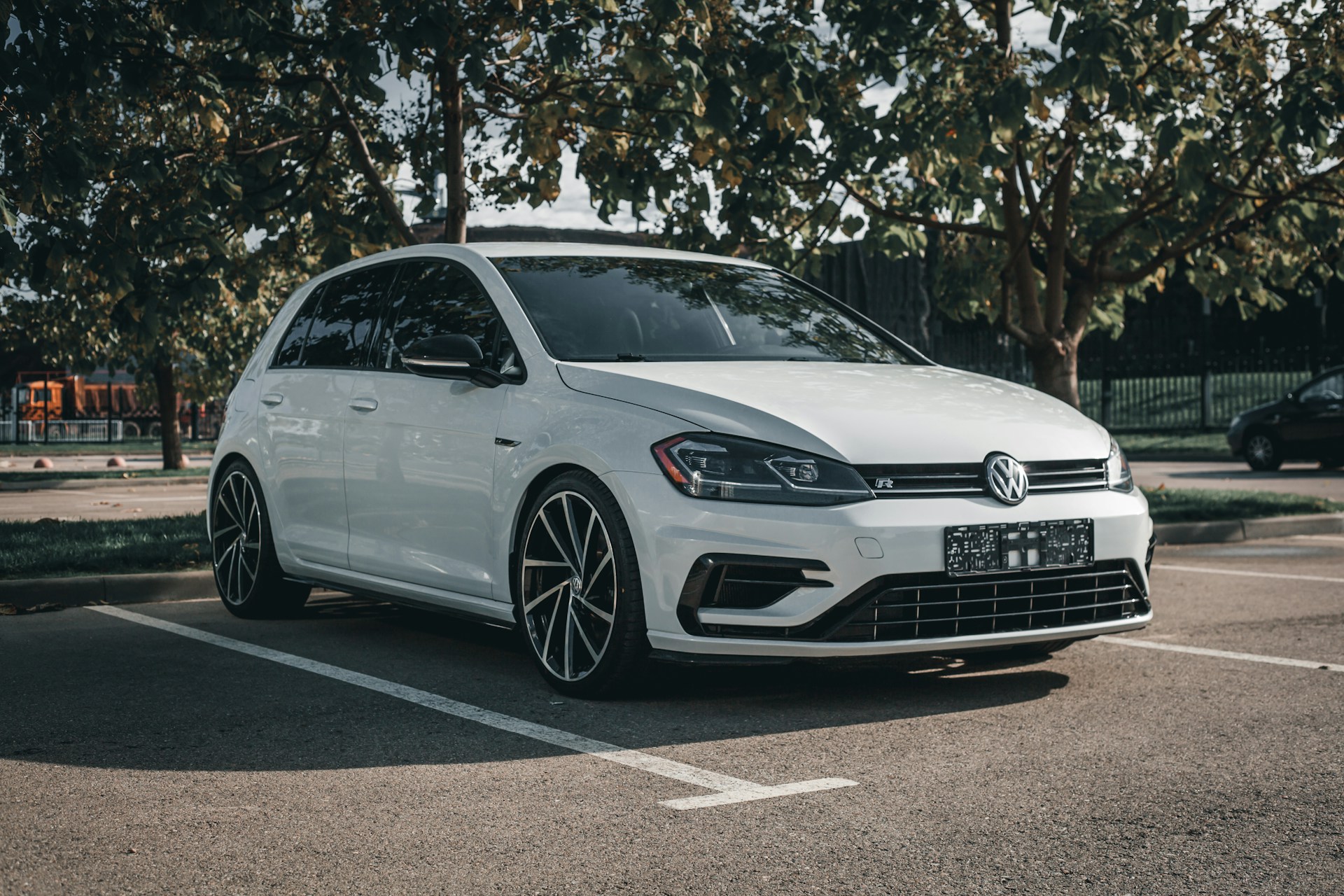 A white car parked in a parking lot