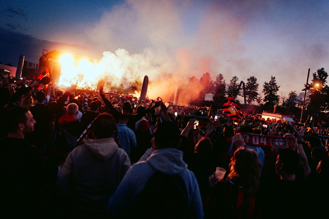 A crowd of people standing around a fire